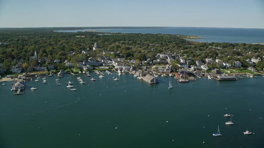 Aerial panorama of a city by the seaside with yachts on a sunny day