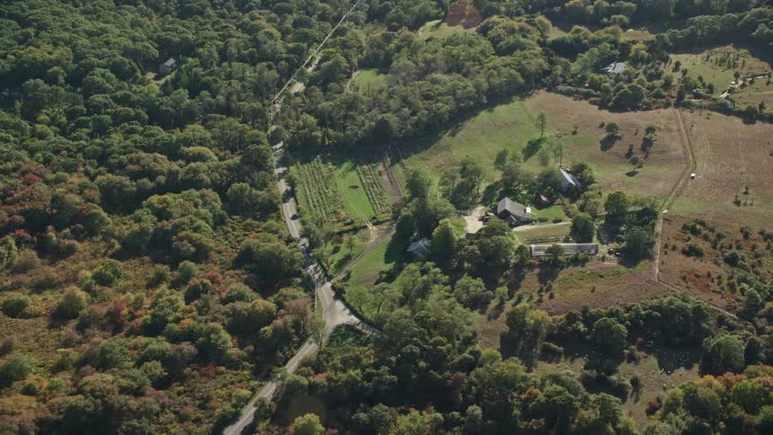 Aerial panorama of a house in the midst of a rural area with extensive vegetation