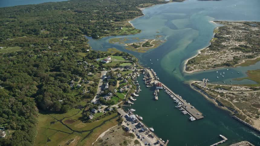 A rural region on an island with a marina full of boats in one section