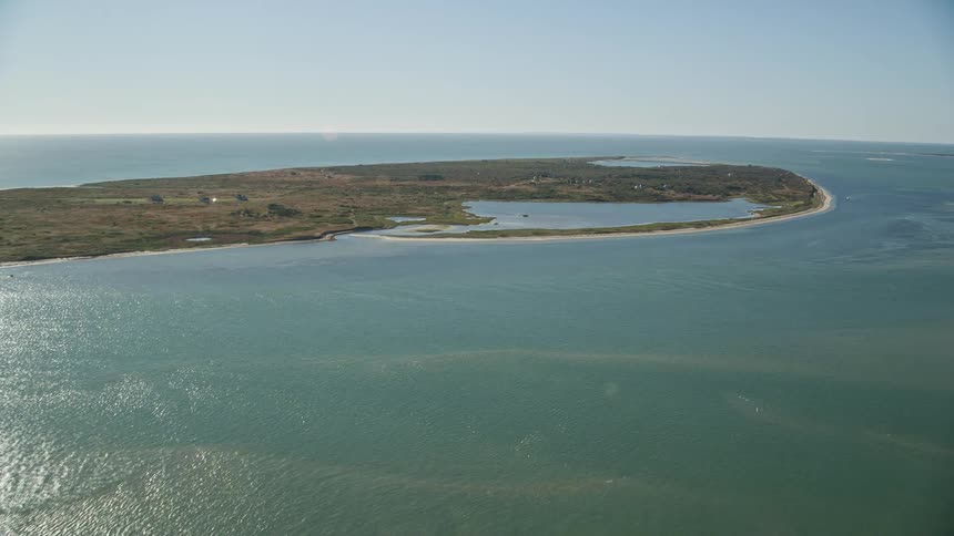 Aerial panorama of an island in the midst of a sea with turquoise waters