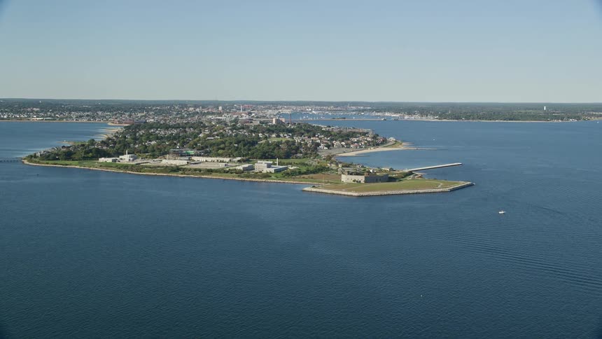A city surrounded by green vegetation on an island next to the sea