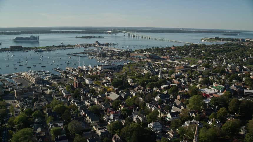 Aerial view of boats on a marina next to a small town