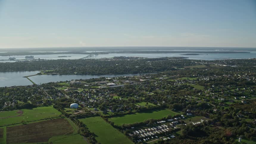 A suburban town surrounded with vegetation close to a river