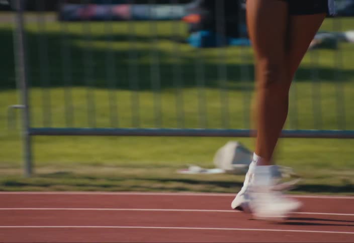 A woman does warm up exercises before a track meet