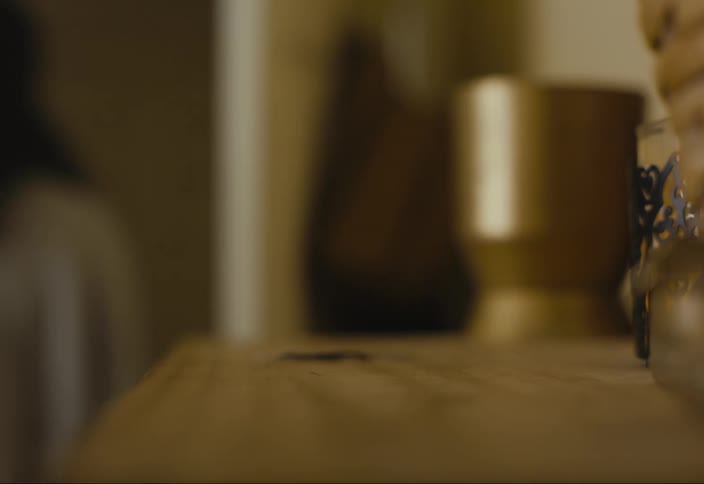 Close up of womans hand reaching out and picking up car keys