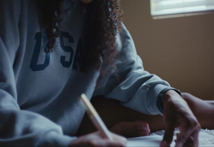 A woman is writing in her notebook