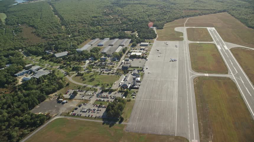 An airport with multiple runway and hangars with some plains seen outside