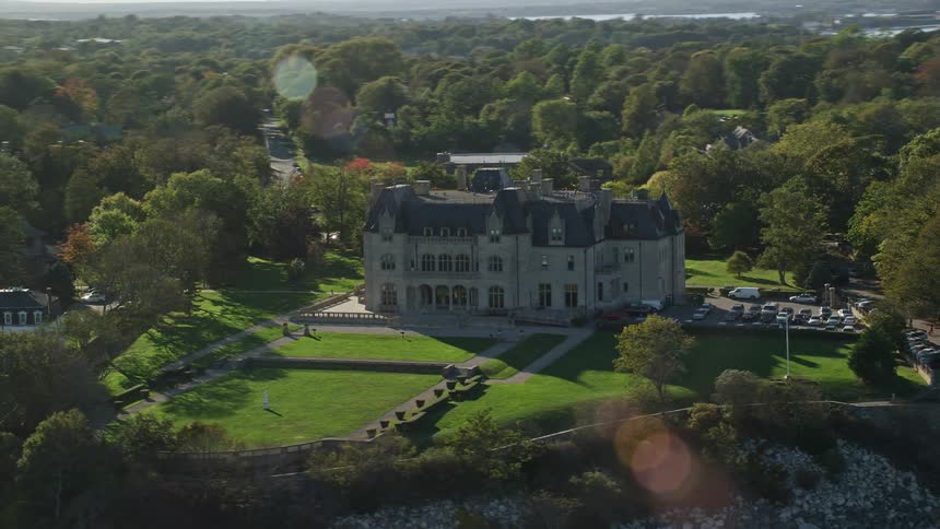 Aerial view of salve regina university and its green yard with a parking lot