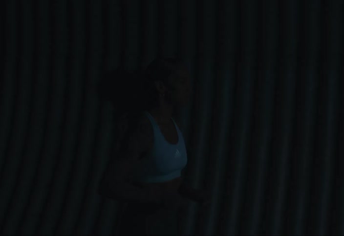 Young woman goes on a run through a tunnel