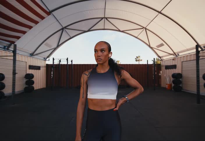 An athlete standing in a gym while wearing a hearing aid