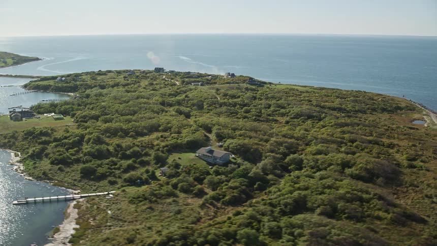 Aerial view capturing a lush green island surrounded by a vast expanse of water