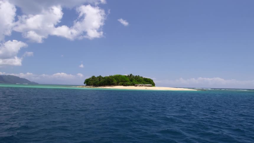 Blue waters lead to a small island ahead