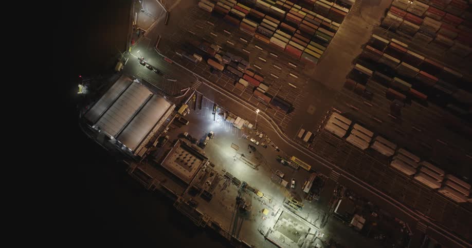 Aerial view of shipping containers on a storage area at night