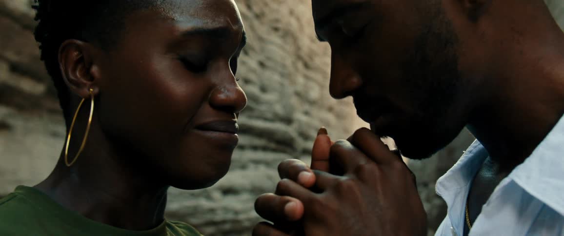 Man kisses a womans hands in a romantic way at midday