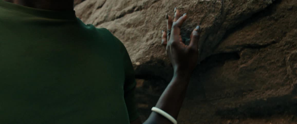 Crying black lady with a hand placed on the rock