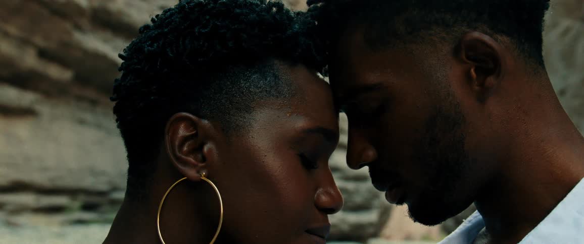A man and woman touch their heads together