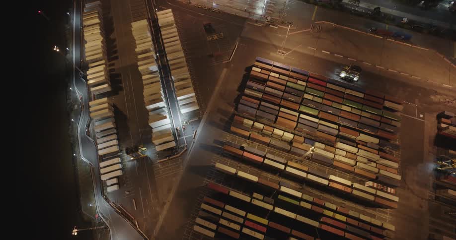 Aerial view of shipping containers on a storage area at night
