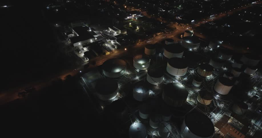 Aerial view of oil storage tanks in the city at night