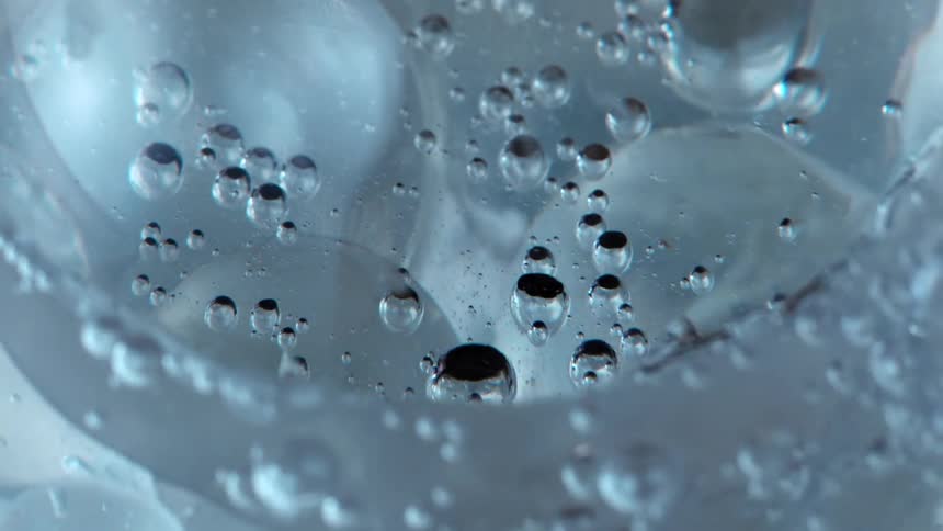 Bubbles bounce and move as they float inside a clear sphere