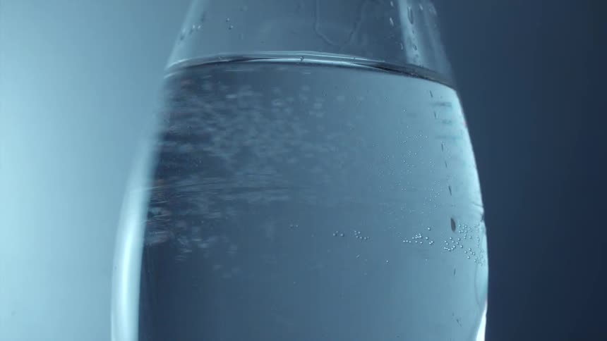 Rounded bottle of water spinning around