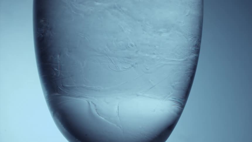 Abstract liquid in motion within a layer of abstract ice