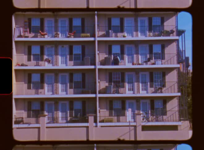 A building with different apartments along a busy road with moving cars