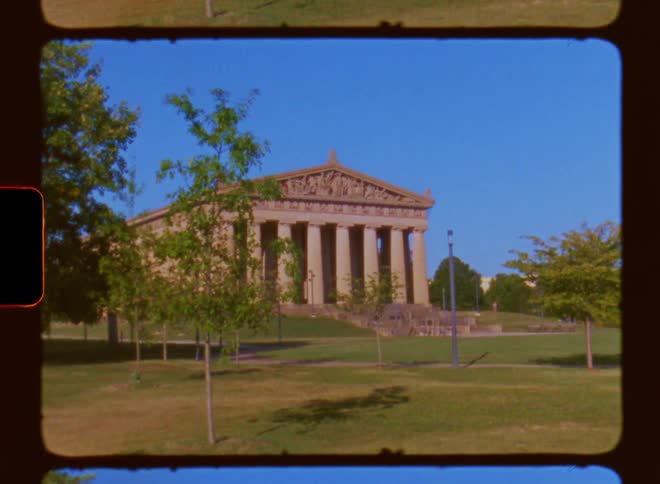 A standalone building with eight pillars and different symbols