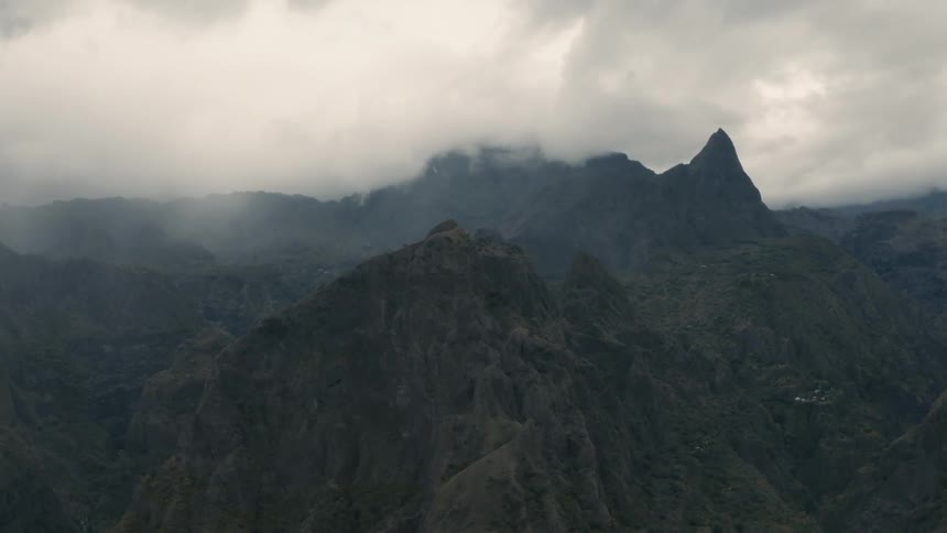 Clouds cover the top of a mountain range