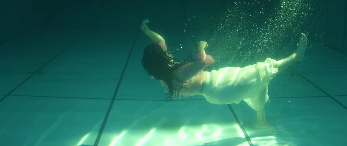 A woman is swimming in a pool