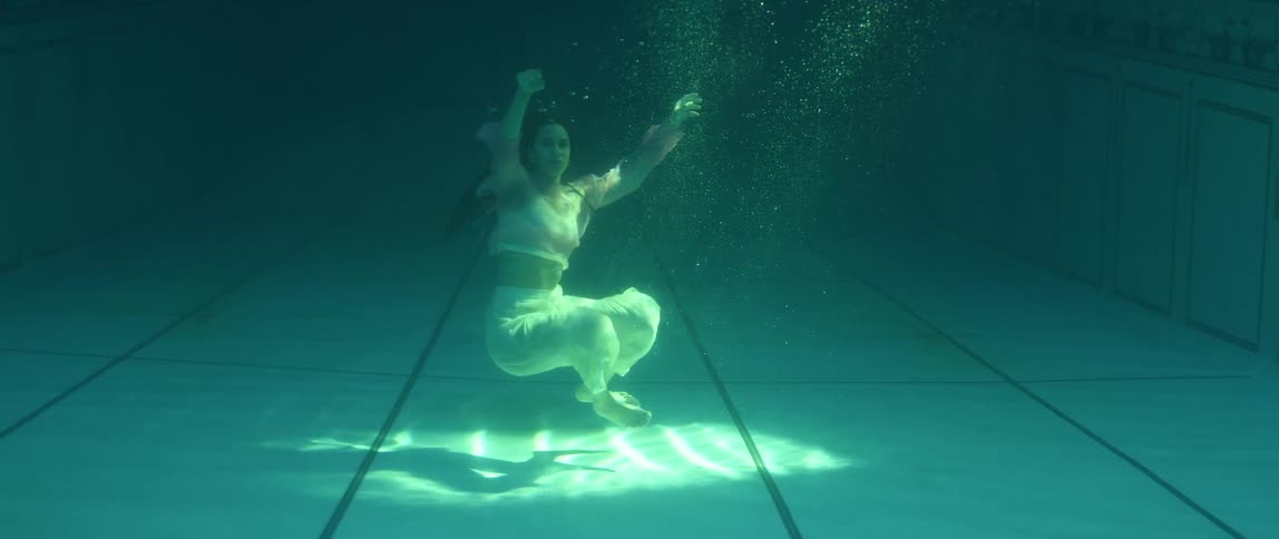 A woman is swimming in a pool
