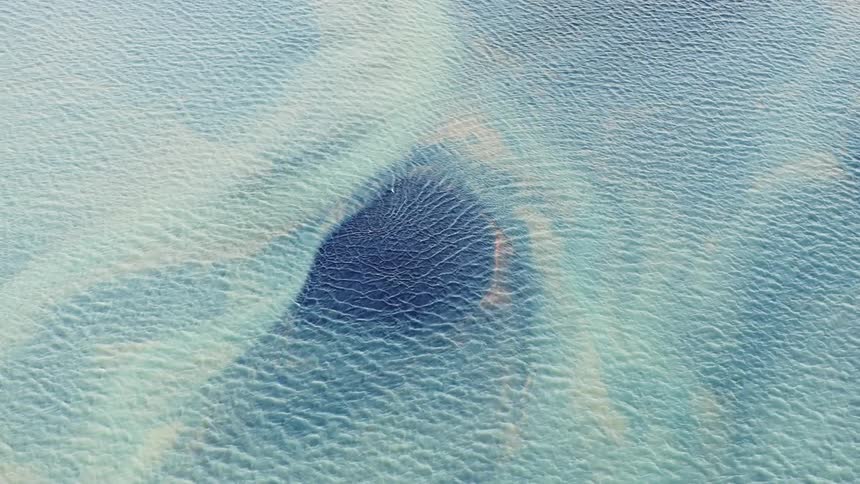 Textured painting forms surface of large body of water