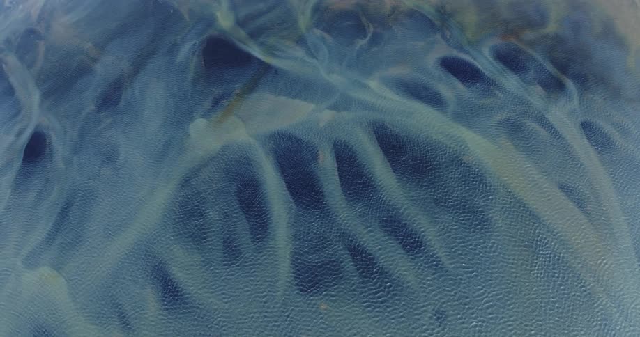 Glacier rivers with various shades of blue and yellow colors
