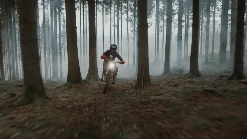 A motorcyclist venturing into the fogcovered forest