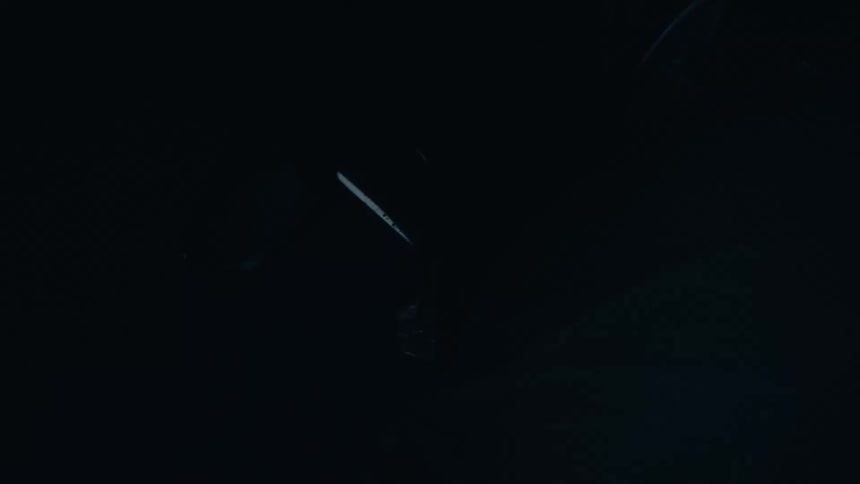 Water drops from helmet of athlete moving through night