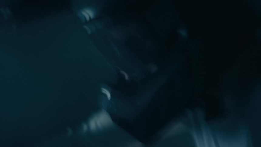 A man riding a motorcycle at high speed in the darkness