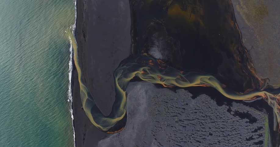 Aerial view of a river meeting the ocean