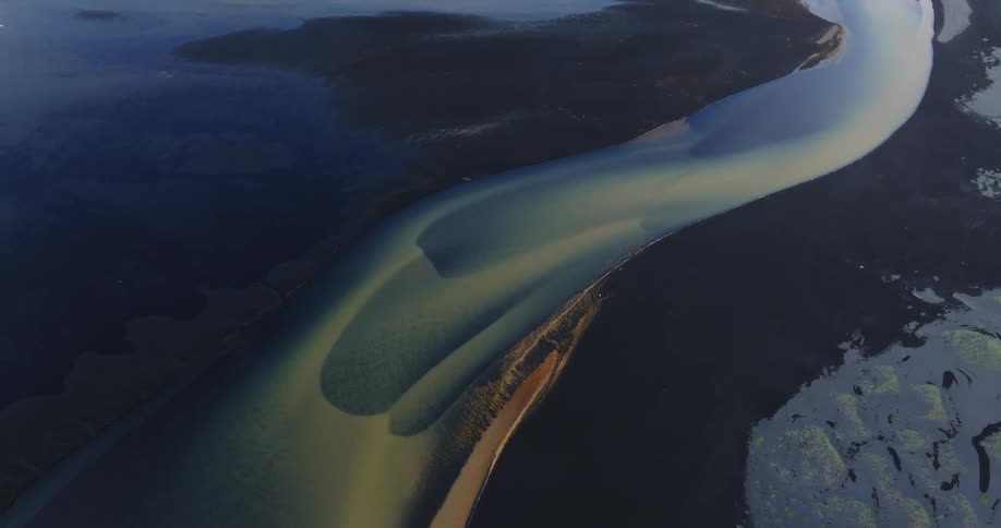 Aerial view of a river meeting the ocean