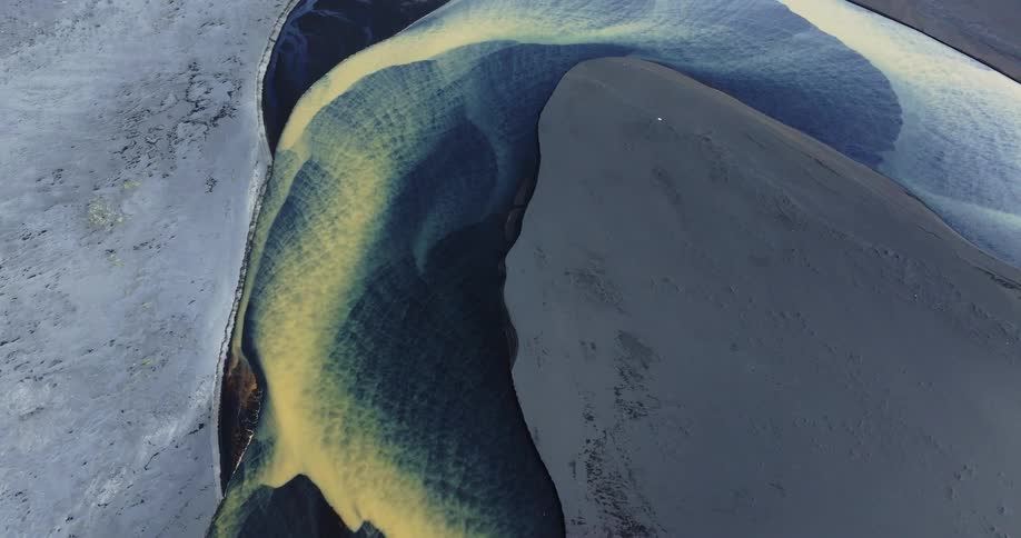 Aerial view of a river with blue and yellow water