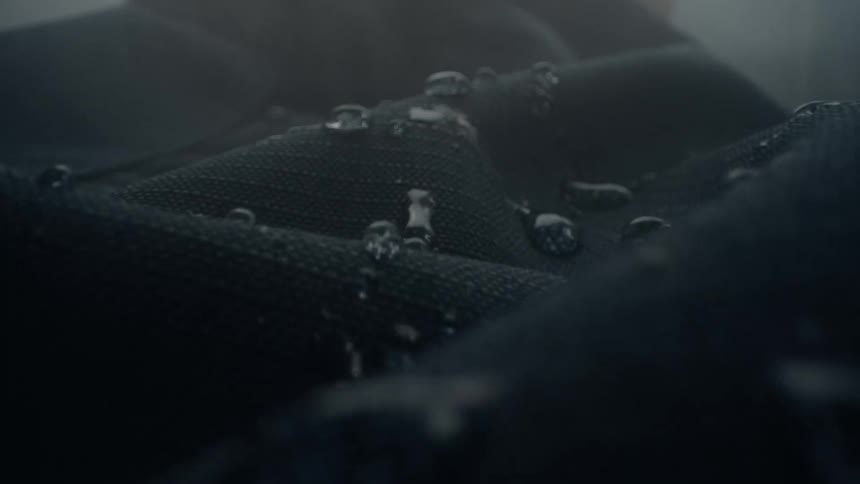 Water drops on waterproof cloth vibrate in wind on a foggy day