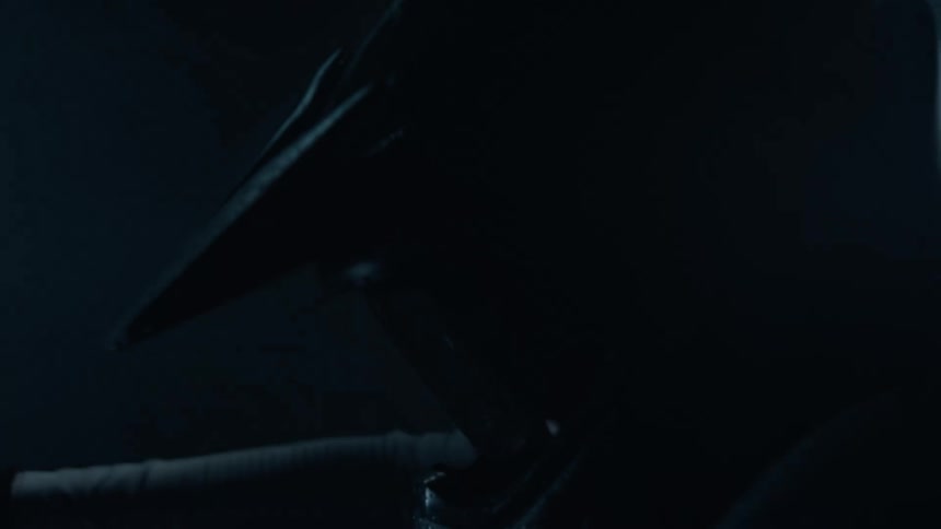 Close up of the helmet of a motorcycle rider under the rain at night