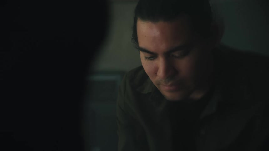 Light shines on a mans face as he looks down