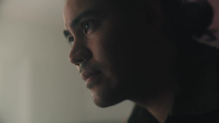 Man looking down with a distressed expression on his face