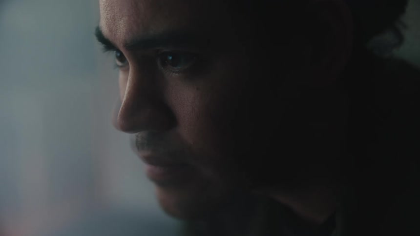 A mans face looking ahead with a worried facial expression