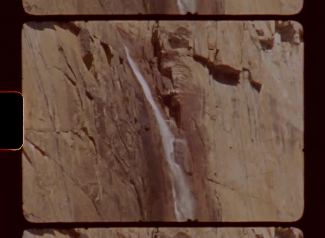 Waterfall pours down the rock face of a mountain