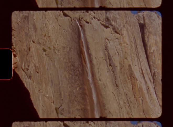 A waterfall flows off the mountain