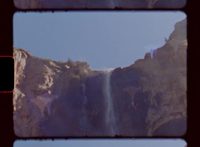 Waterfall falling from the mountain peak during the day