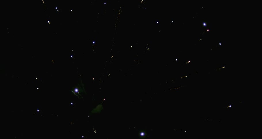 Firework starburst spreads through the night sky then fades