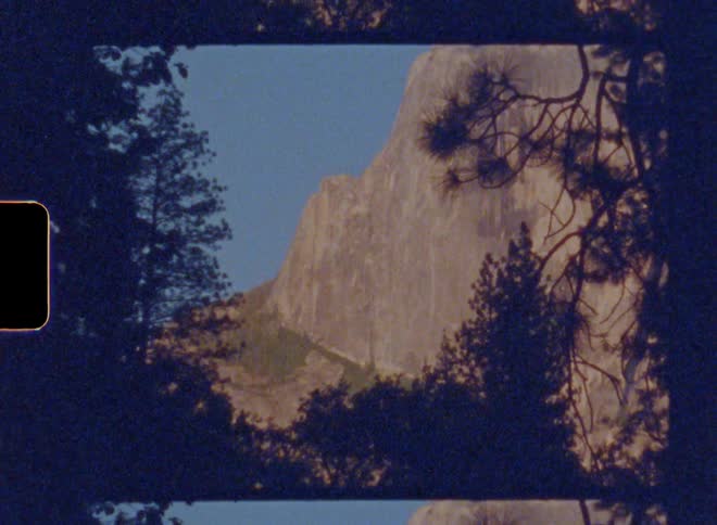 Peak of a mountain near some trees at midday