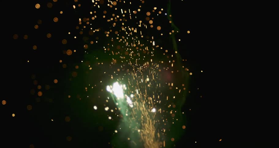 A stream of gold particles flowing and bursting across the darkness