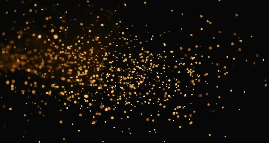 A stream of gold particles flowing and bursting across the darkness
